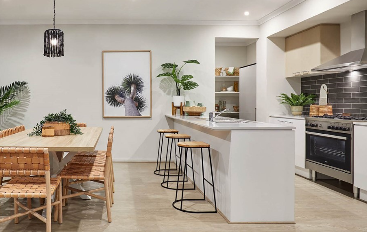 Kitchen interior showing a white bench, stools and a wooden dining table